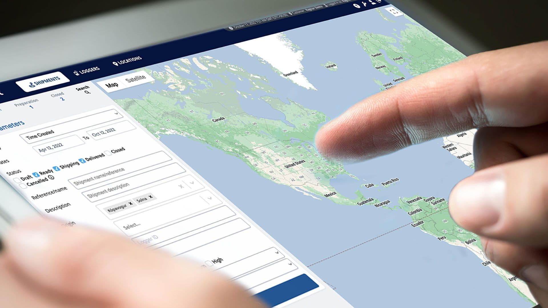 A hand on a tablet showing the Controlant platform's shipment map