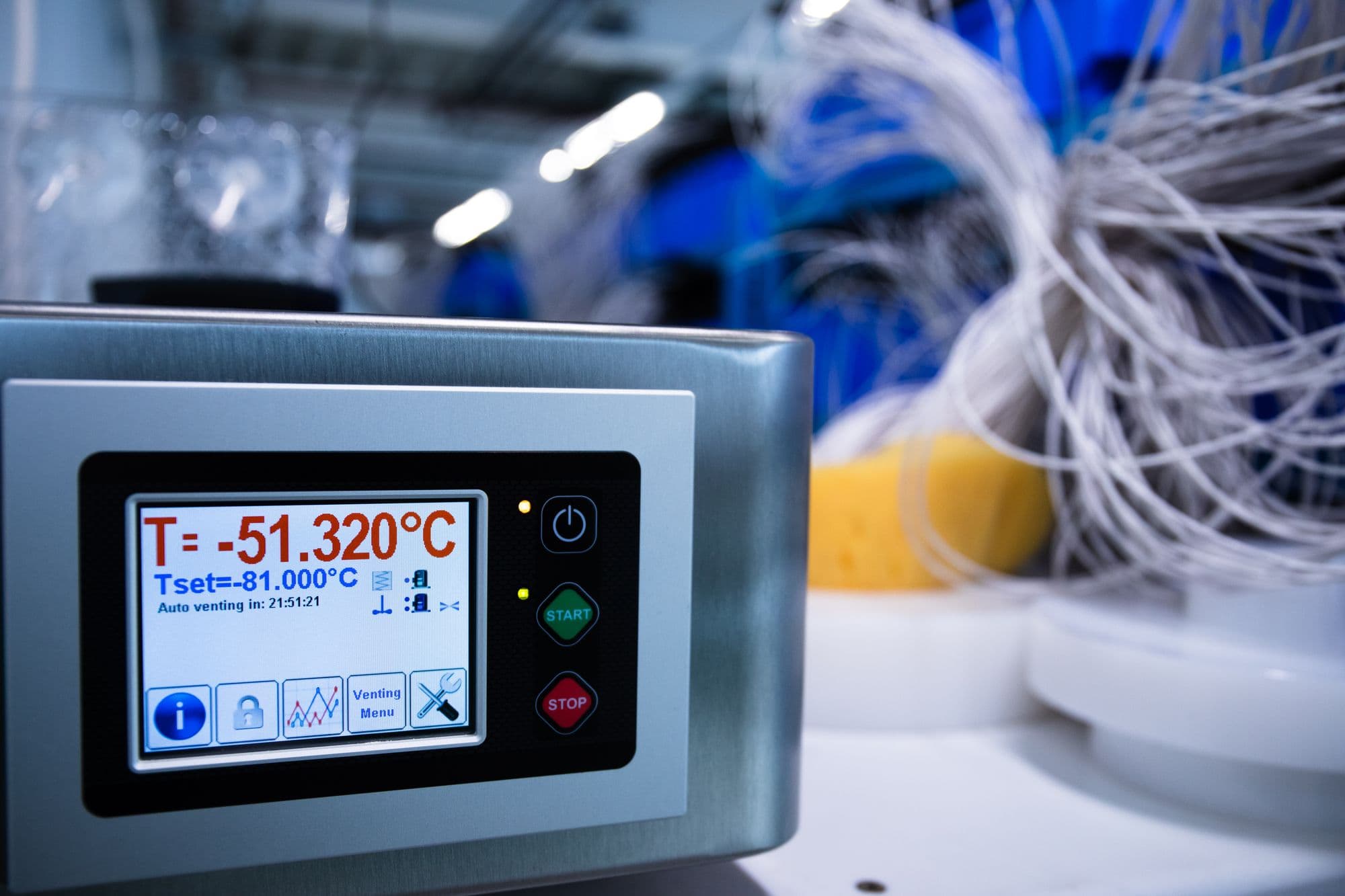 A deep-freeze chamber controller reading minus 51.320ยฐC against a set point of minus 81ยฐC, with probe harnesses behind it